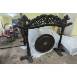 Chinese large gong on carved stand with decoration of dragons to top. Column supports on T