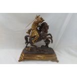 Bronzed ormolu metal figure of a medieval French King in armour and crown, on horseback, with a