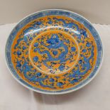 Chinese porcelain dish with blue decoration of dragons and lotus flowers with orange ground,