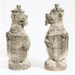 Pair of Antique Cast Stone Opposing Heraldic Lions , each wearing a crown and holding a royal