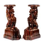 Pair of Continental Majolica Pedestals , late 19th c., modeled as griffins on shaped plinths,