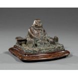 American Bronze Figural Inkwell , 19th c., modeled as portly man with tray of roasted turkey, wood