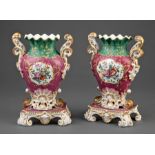 Pair of Paris Polychrome and Gilt Porcelain Urns , 19th c., with floral reserves on claret