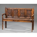 English Carved Oak Hall Bench , 19th c., turned finials, back fitted with earlier carved panels,