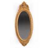 Pair of Antique French Giltwood Mirrors , pierced rocaille crest, foliate rope-molded surround, oval