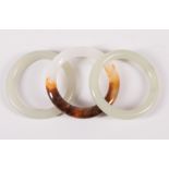 Two Chinese Pale Celadon Jade Bangle Bracelets , dia. (ext.) 3 1/8 in. and 3 in., dia. (int.) 2 1/