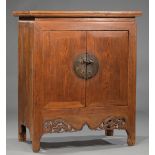 Chinese Brass-Mounted Carved Wood Cabinet , 20th c., waisted rectangular top, two doors, void