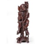 Chinese Hardwood Figure of a Luohan , carved leaning on a staff beside a bird at his feet with a