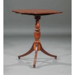 Small Regency Mahogany Tilt-Top Table , early 19th c., shaped top, vasiform standard, reeded sabre