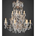 Pair of Continental Gilt Metal and Crystal Twelve-Light Chandeliers , scrolling arms with cut