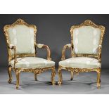 Pair of Continental Rococo-Style Giltwood Fauteuils , rocaille crest, foliate scrolled arms,