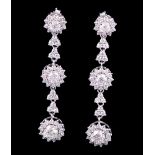 Pair of 18 kt. White Gold and Diamond Earrings , each set with 3 round diamonds, total wt. 2.79