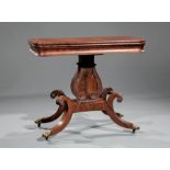 American Classical Carved Mahogany Games Table , early 19th c., foldover swivel top, ogee frieze,