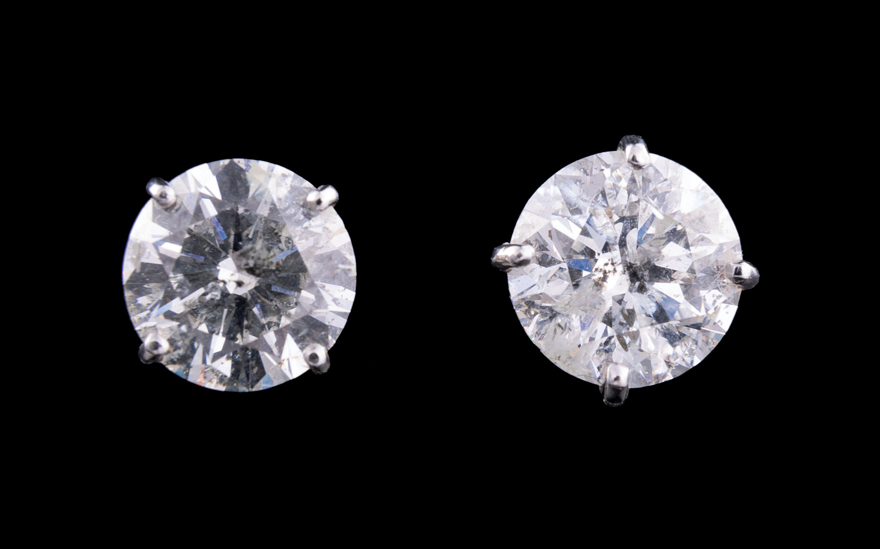 Pair of Large Platinum and Diamond Stud Earrings, 2 prong set round brilliant cut diamonds,