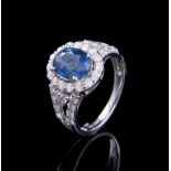 Platinum, Sapphire and Diamond Ring, central prong set oval mixed cut blue sapphire, 3.01 cts., 9.41