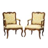 Pair of Italian Rococo Carved Fruitwood Armchairs, later 18th/early 19th c., shell and foliate