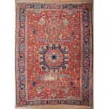 Antique Heriz Carpet, red orange ground, blue border, central medallion, stylized floral design, 9
