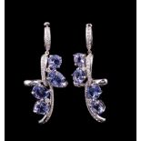 Pair of 14 kt. White Gold, Tanzanite and Diamond Dangle Earrings, comprised of 4 prong set round