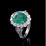 18 kt. White Gold, Emerald and Diamond Ring, central oval mixed cut emerald, 3.58 cts., 11.76 x 9.51
