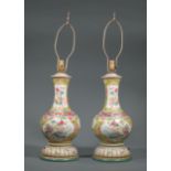 Pair of Chinese Famille Jaune Porcelain Bottle Vases, decorated with antiques and flowers, h. 15