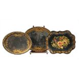 Two Graduated Antique Tole Peinte Trays, black with gilt decoration, on stand; together with a