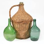 Three Green Blown Glass Demijohns, 19th/20th c., incl. wicker encased bottle, h. 19 1/2 in.; mold-
