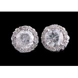 Pair of 18 kt. White Gold and Diamond Stud Earrings, 2 central prong set round cut diamonds, total