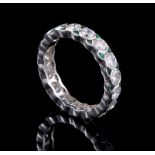 Platinum, Diamond and Emerald Eternity Ring, comprised of 17 bezel set round cut diamonds flanked by