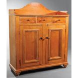 American Pine and Poplar Cabinet, 19th c., shaped backsplash, three frieze drawers, paneled doors,