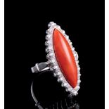 18 kt. White Gold, Coral and Diamond Ring, central cabochon marquise coral set within surround of 24