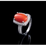 14 kt. White Gold, Coral and Diamond Ring, central prong set oval cabochon coral, wt. approx. 4.13
