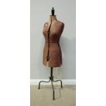 An adjustable dress makers mannequin by Chil-Daw, raised on black metal support to bent-metal tri-