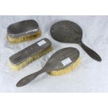 A four-piece silver backed brush and mirror set, as found