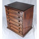 A small mahogany table-top collectors cabinet of six drawers with turned pulls, 31cm wide