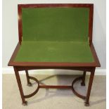 An early 20th century mahogany folding card table of rectangular form, on square supports and