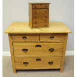 A pine chest of two short over two long graduated drawers, 96cm, together with a miniature chest