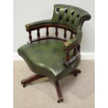 A mahogany captain's swivel chair with green leather upholstery