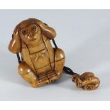 A Japanese carved boxwood Inro modelled as a monkey wearing a Jerkin, with baby monkey netsuke