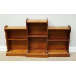 A stained mahogany breakfront bookcase, the raised central section with single shelf, flanked by two