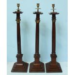 A set of three early 20th century Masonic oak candlesticks, the three columns comprising Ionic,