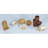 Four Japanese carved boxwood netsuke comprising boy & fish, elephant, eagle head and ball of snakes,