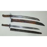 An early 20th century British Lee Enfield bayonet with scabbard and a German jungle-knife with