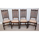 A set of four 1920s stained oak standard chairs, drop in seats with peach floral upholstery raised