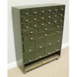 A large green metal tool/storage cabinet with 18 small drawers above 6 larger drawers and 8