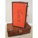 A brown leather travelling trunk, with studded top, brass lock, canvas lining and wooden bars to