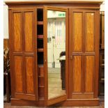 An Edwardian walnut and satinwood triple wardrobe-linen press, with central mirrored door