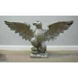 A large silver-painted carved wooden eagle, on naturalistic platform base, wingspan 120cm wide