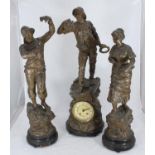 A late 19th / early 20th century patinated spelter clock garniture modelled with a fisherman