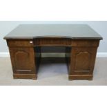 A stained walnut inverted break-front pedestal desk, with central frieze drawer, flanked by two