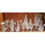 A shelf of assorted glasswares including a decanter, large vase, metal-topped glass Stein,